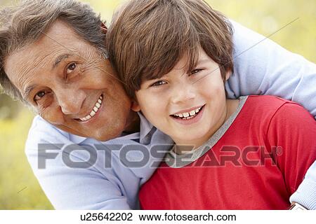 Stock Image - Hispanic grandfather and grandson. Fotosearch