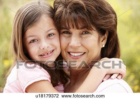 Stock Image - Hispanic grandmother and granddaughter. Fotosearch