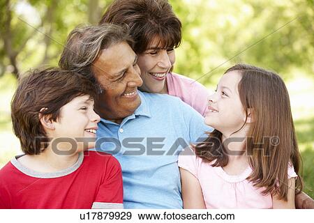 Stock Photo - Hispanic grandparents and grandchildren outdoors. Fotosearch
