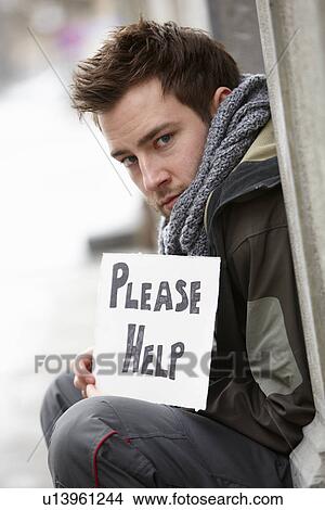 Picture - Homeless Young Man Begging In Street. Fotosearch