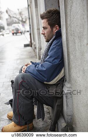 Stock Photo - Homeless Young Man Begging In Street. Fotosearch