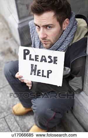 Stock Photography - Homeless Young Man Begging In Street. Fotosearch