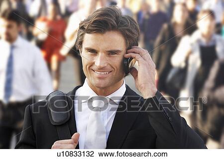 Male commuter in crowd using phone View Large Photo Image Stock Image - Male commuter in crowd using phone. Fotosearch