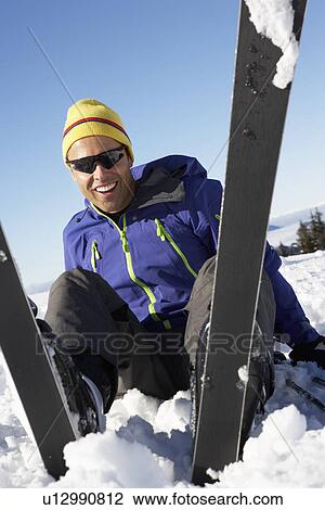 Male Skier Sitting In Snow With After Fall View Large Photo Image Stock Image - Male Skier Sitting In Snow With After Fall. Fotosearch