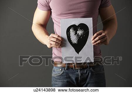 Stock Photo - Man holding ink drawing of heart. Fotosearch