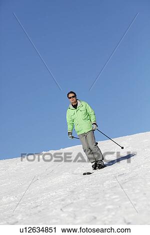 Stock Image - Man On Ski Holiday In Mountains. Fotosearch