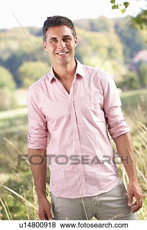 Stock Photo - Man outdoors in countryside. Fotosearch