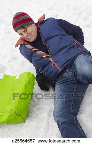 Stock Photo - Man Slipped And Injured Back On Icy Street. Fotosearch