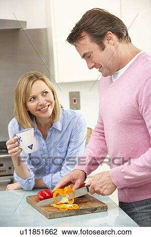 Mature couple preparing meal in domestic kitchen View Large Photo Image Stock Image - Mature couple preparing meal in domestic kitchen. Fotosearch