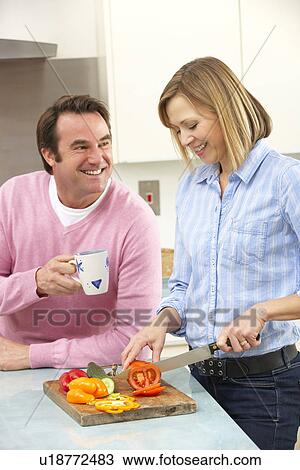 Mature couple preparing meal in domestic kitchen View Large Photo Image Stock Image - Mature couple preparing meal in domestic kitchen. Fotosearch