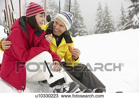 Middle Aged Couple Eating Sandwich On Ski Holiday In Mountains View Large Photo Image Stock Image - Middle Aged Couple Eating Sandwich On Ski Holiday In Mountains. Fotosearch