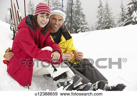 Middle Aged Couple Eating Sandwich On Ski Holiday In Mountains View Large Photo Image Stock Photo - Middle Aged Couple Eating Sandwich On Ski Holiday In Mountains. Fotosearch