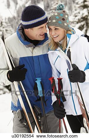 Middle Aged Couple On Ski Holiday In Mountains View Large Photo Image Picture - Middle Aged Couple On Ski Holiday In Mountains. Fotosearch