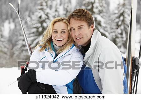 Middle Aged Couple On Ski Holiday In Mountains View Large Photo Image Stock Image - Middle Aged Couple On Ski Holiday In Mountains. Fotosearch