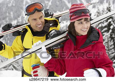 Stock Photo - Middle Aged Couple On Ski Holiday In Mountains. Fotosearch