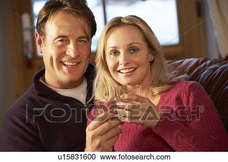 Middle Aged Couple Sitting On Sofa With Glasses Of Whisky View Large Photo Image Stock Image - Middle Aged Couple Sitting On Sofa With Glasses Of Whisky. Fotosearch