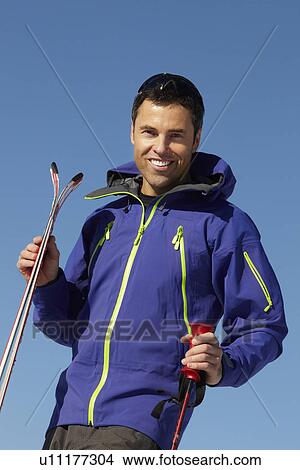 Picture - Middle Aged Man On Ski Holiday In Mountains. Fotosearch