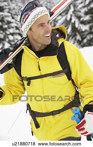 Stock Photo - Middle Aged Man On Ski Holiday In Mountains. Fotosearch