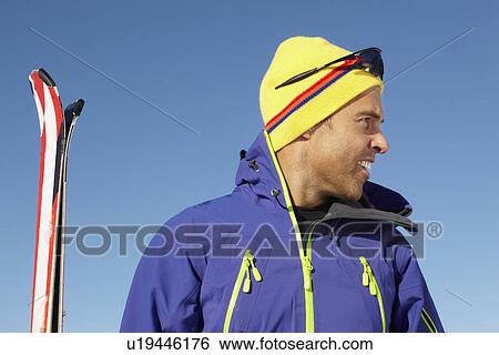 Stock Photograph - Middle Aged Man On Ski Holiday In Mountains. Fotosearch