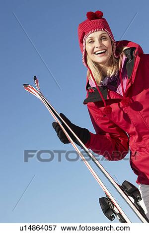 Stock Photo - Middle Aged Woman On Ski Holiday In Mountains. Fotosearch