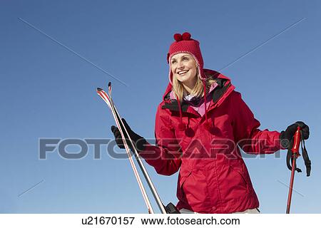 Stock Photo - Middle Aged Woman On Ski Holiday In Mountains. Fotosearch