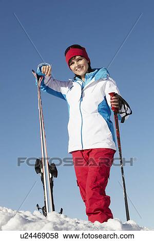Stock Photo - Middle Aged Woman On Ski Holiday In Mountains. Fotosearch