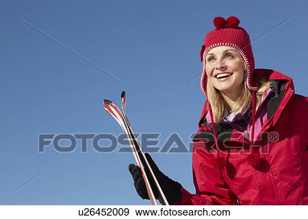 Stock Photo - Middle Aged Woman On Ski Holiday In Mountains. Fotosearch