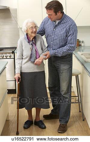 Mother and adult son in kitchen View Large Photo Image Stock Image - Mother and adult son in kitchen. Fotosearch