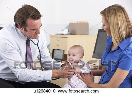 Stock Image - Mother and baby in doctor's surgery. Fotosearch