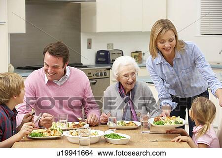 Picture - Multi-generation family sharing meal together. Fotosearch