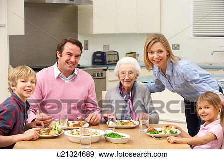 Multi-generation family sharing meal together View Large Photo Image Stock Photo - Multi-generation family sharing meal together. Fotosearch