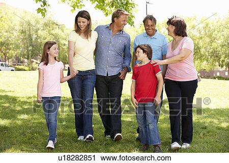 Stock Image - Multi generation Hispanic family in park. Fotosearch