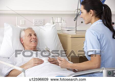Stock Photo - Nurse and male patient in UK Accident and Emergency. Fotosearch