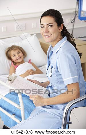 Stock Photo - Nurse with child patient in UK Accident and Emergency. Fotosearch