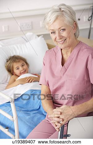 Stock Photo - Nurse with child patient in USA Accident and Emergency. Fotosearch