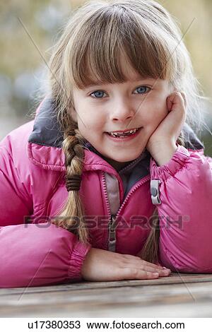 Stock Image - Outdoor Portrait Of Young Girl Wearing Winter Clothes. Fotosearch