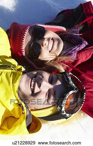 Overhead View Of Mother And Teenage Son Lying In Snow On Ski Holiday In Mountains View Large Photo Image Stock Photo - Overhead View Of Mother And Teenage Son Lying In Snow On Ski Holiday In Mountains. Fotosearch