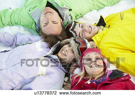 Overhead View Of Teenage Family Lying In Snow On Ski Holiday In Mountains View Large Photo Image Stock Image - Overhead View Of Teenage Family Lying In Snow On Ski Holiday In Mountains. Fotosearch