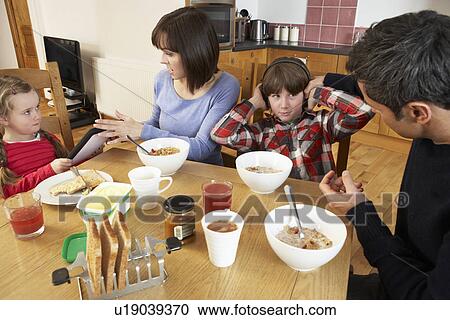 Parents Taking Away Gadgets From Children Whilst Eating Breakfast Together In Kitchen View Large Photo Image Stock Image - Parents Taking Away Gadgets From Children Whilst Eating Breakfast Together In Kitchen. Fotosearch