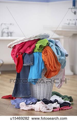 Stock Image - Pile of dirty washing in bathroom. Fotosearch