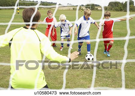 Stock Image - Player ready to score goal in Junior 5 a side. Fotosearch