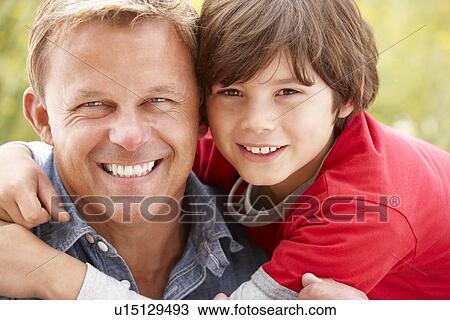 Stock Image - Portrait father and son outdoors. Fotosearch