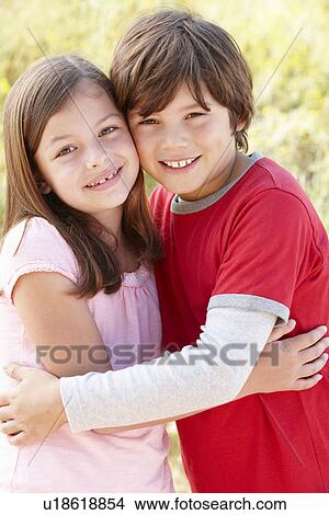 Picture - Portrait hispanic brother and sister outdoors. Fotosearch