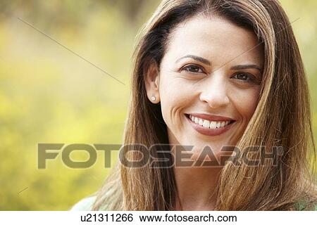 Stock Photograph - Portrait hispanic woman outdoors. Fotosearch