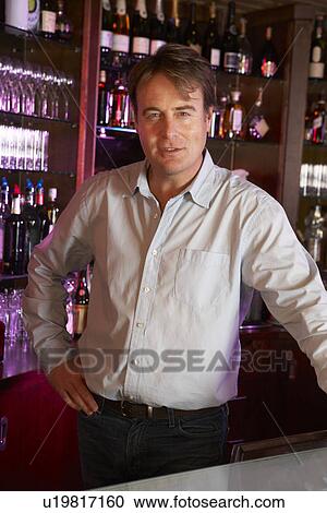 Portrait Of Barman Standing Behind Bar View Large Photo Image Stock Image - Portrait Of Barman Standing Behind Bar. Fotosearch