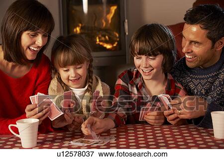 Portrait Of Family Playing Cards By Cosy Log Fire View Large Photo Image Stock Photo - Portrait Of Family Playing Cards By Cosy Log Fire. Fotosearch