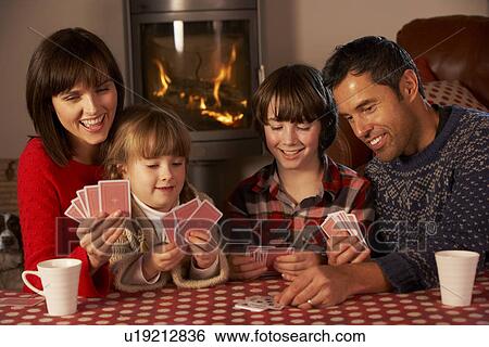 Portrait Of Family Playing Cards By Cosy Log Fire View Large Photo Image Stock Photograph - Portrait Of Family Playing Cards By Cosy Log Fire. Fotosearch
