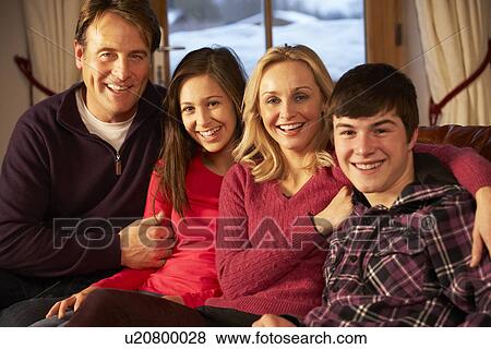 Stock Photo - Portrait Of Family Relaxing On Sofa Together. Fotosearch