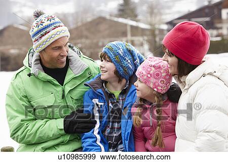 Portrait Of Family Wearing Winter Clothes In Snowy Landscape View Large Photo Image Stock Photo - Portrait Of Family Wearing Winter Clothes In Snowy Landscape. Fotosearch