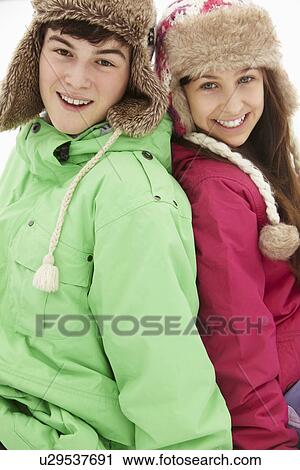 Portrait Of Teenage Couple In Snow Wearing Fur Hats View Large Photo Image Stock Image - Portrait Of Teenage Couple In Snow Wearing Fur Hats. Fotosearch
